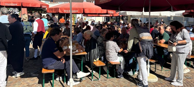 Bierbänke mit Menschen an der Essmeile beim Bähnlesfest 2025