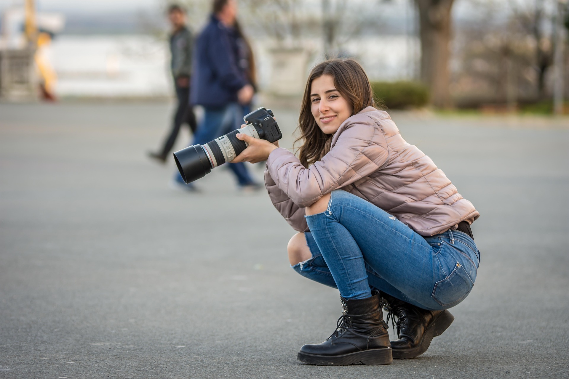 Frau hockend mit Fotoapparat