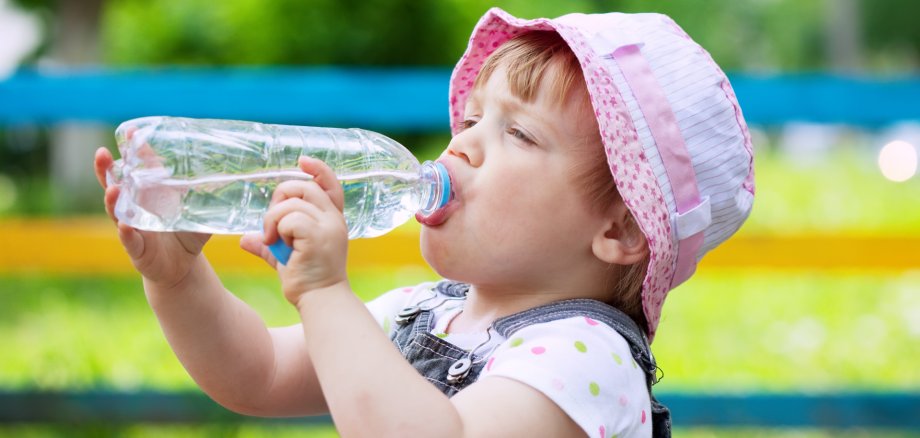 two-year child drinks from bottle