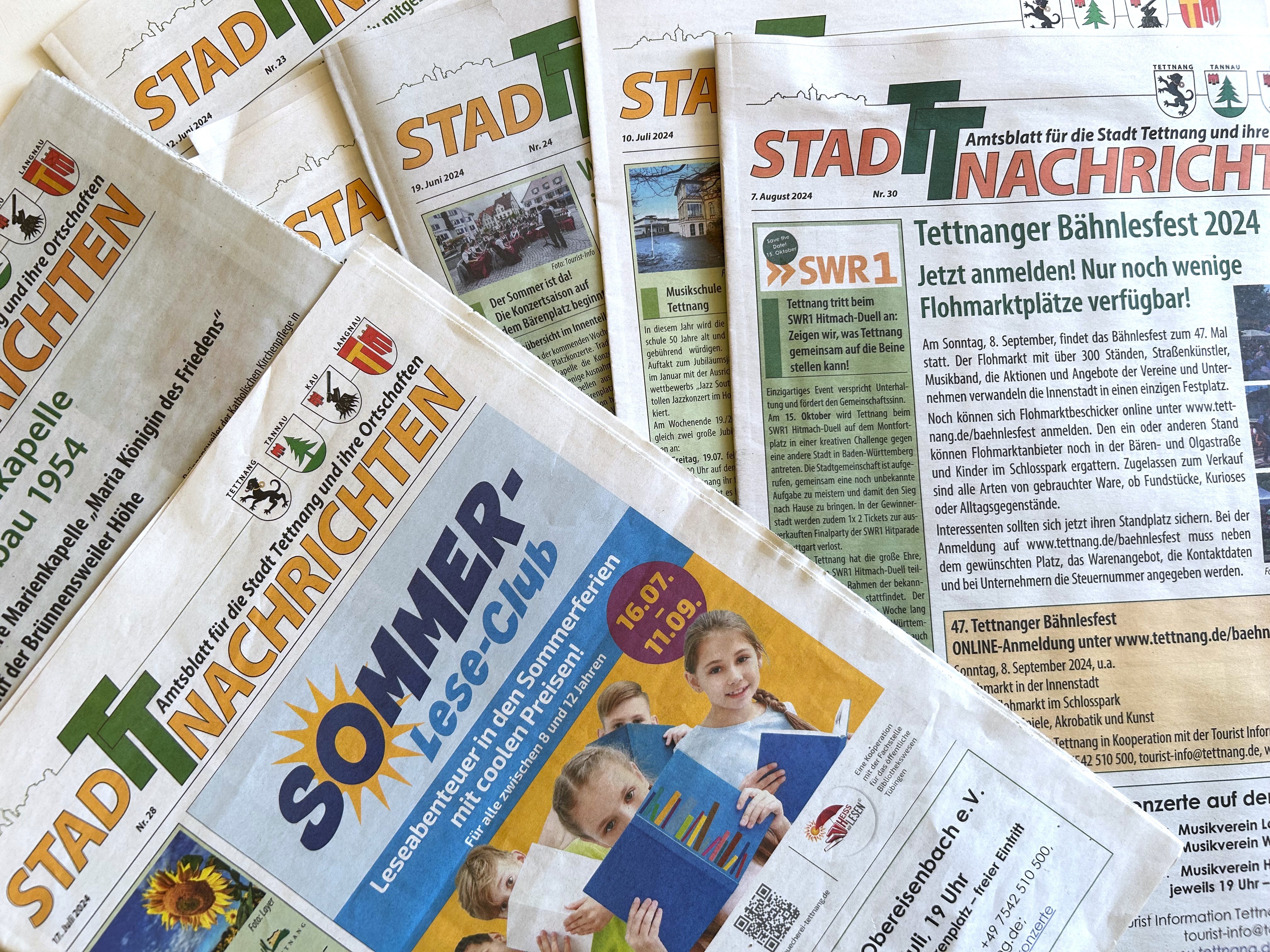 Mehrere Ausgaben der StadTTnachrichten über und nebeneinander